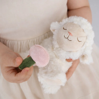 White lamb plush toy held by a child alongside a soft pink flower Dinkum Pets cuddly gift for babies toddlers and kids