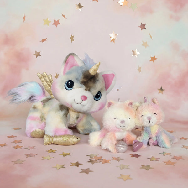 Two plush unicorn toys on a pink background with star decorations