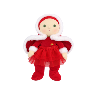 Plush doll with red hair, embroidered green eyes and rosy cheeks, wearing a red velvet hooded cape with white fluffy trim over a red outfit with a tulle skirt, white fluffy cuffs and a small rainbow patch on the chest.