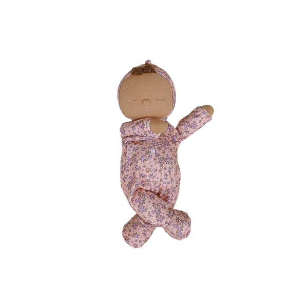 Baby doll in a floral outfit on a white background