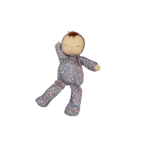 Baby doll in a floral onesie on a white background