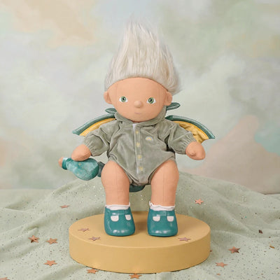 Dragon Griffin doll with white hair, green outfit, teal shoes, colorful wings, and a potion bottle, posed on a pedestal by Dinkum Dolls