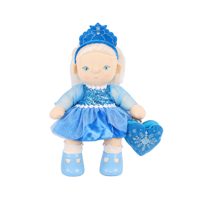 Plush doll with white hair, blue eyes and rosy cheeks, wearing a blue velvet tiara, a sequinned blue dress with sheer sparkly sleeves and a tulle skirt, white frilled socks, light blue shoes, and a blue heart-shaped bag with an embroidered snowflake.