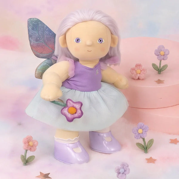 Fairy doll with purple outfit and butterfly wings on a pastel background