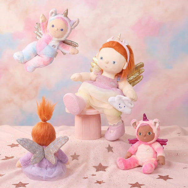 Set of fairy-themed dolls and plush toys on a soft, cloud-like background.