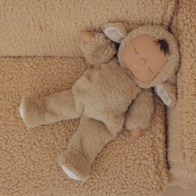 Cozy Dinkums Lamby Pip plush lamb doll by Dozy Dinkums, wearing a soft fluffy suit and resting on a beige fleece blanket.