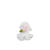White plush toy sheep with a pink flower on a white background
