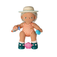 A plush doll with white hair wearing a straw hat, an orange and white striped swimsuit, teal boots, and a pink seashell accessory, holding a fish toy and a blue ball on a white background.