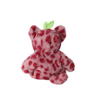 Back view of Cozy Dinkum Cherry Cheetah plush doll with soft pink fur, deep red spots, rounded ears, and a green leaf detail by Dinkum Dolls by Olli Ella