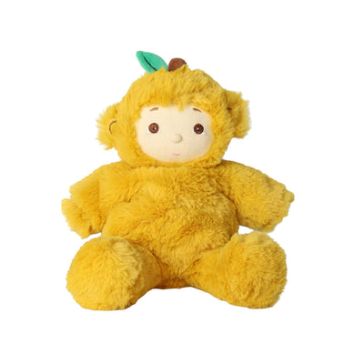 A yellow plush monkey toy with a soft furry texture, a cream-colored face, brown eyes, and a small green leaf on its head, sitting against a plain white background.