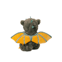 Plush toy resembling a dragon with yellow wings on a white background