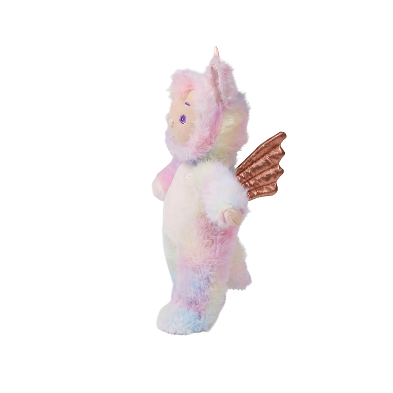 Pastel plush unicorn doll with soft pink, blue, and yellow fur and brown wings, shown in side profile from Cozy Day Dinkums