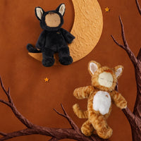 Black Cozy Dinkum Cat plush toy perched on a crescent moon beside an orange tabby plush, styled by Dinkum Dolls by Olli Ella in a warm woodland scene