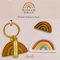 Dinkum Dolls rainbow pack with a rainbow keychain, enamel pin, and embroidered rainbow badge displayed on branded backing card