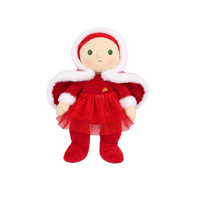 Plush doll with red hair, embroidered green eyes and rosy cheeks, wearing a red velvet hooded cape with white fluffy trim over a red outfit with a tulle skirt, white fluffy cuffs and a small rainbow patch on the chest.