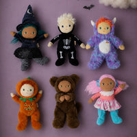 Miles Monster is a purple fuzzy doll with orange hair, small horns and a white belly, pictured with five Halloween themed Dinky Dinkum dolls by Olli Ella