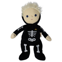 Dinky Dinkum Scully Skeleton plush doll by Dinkum Dolls by Olli Ella with blond hair, a black outfit, white bone details, and a rainbow patch