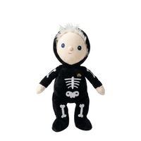Dinky Dinkum Scully Skeleton plush doll in a black skeleton outfit with white bone details, rainbow chest accent and white hair by Dinkum Dolls by Olli Ella