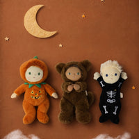 Dinky Dinkum Wesley Werewolf in a brown furry costume beside pumpkin and skeleton dolls, styled with a crescent moon and stars by Dinkum Dolls by Olli Ella