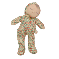 Soft baby doll with sleepy embroidered closed eyes, a smiling mouth and a tuft of brown hair, wearing a cream footed sleepsuit and matching bonnet printed with small red and green sprigs.