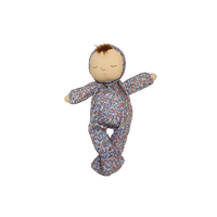 Stuffed doll in a floral outfit on a white background