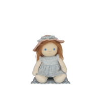 Stuffed doll with a pink hat and gray dress on a white background