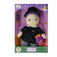 Boxed Willa Witch doll with purple hair wearing a black witch dress and hat holding a purple moon treat bag from Dinkum Dolls by Olli Ella
