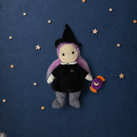 Willa witch doll with pink hair black hat and dress striped leggings and a purple candy accessory on a starry blue background by Dinkum Dolls by Olli Ella