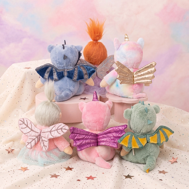 Six colorful Dinky Dinkums fairy plush dolls with soft wings and whimsical hair gathered on starry fabric in a pastel Rainbow Realm setting.