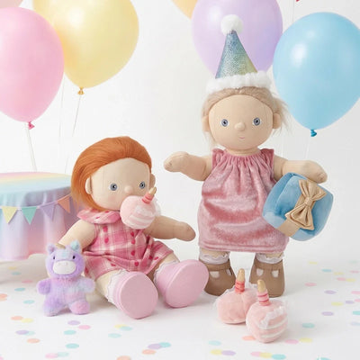Two dolls with balloons and party decorations on a white background