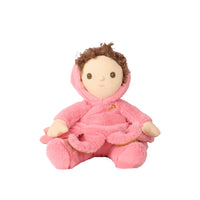 A plush doll with brown curly hair, a beige face, and a pink fuzzy hooded outfit, seated against a plain white background.