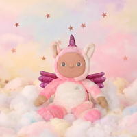 Plush toy in a unicorn costume sitting on fluffy clouds with a pastel starry background
