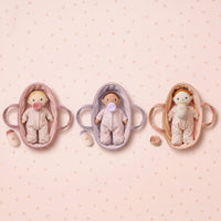 Three baby in different colors on a pink polka dot background
