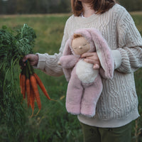 Soft and cuddly pink bunny plush doll with floppy ears. Posable and gently weighted for a calming presence. This bunny soft toy is the ideal companion from birth.