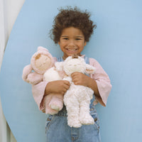 Soft and cuddly ivory lamb plush doll. Posable and gently weighted for a calming presence. This lamb soft toy is the ideal companion from birth.