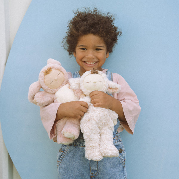 Soft and cuddly ivory lamb plush doll. Posable and gently weighted for a calming presence. This lamb soft toy is the ideal companion from birth.