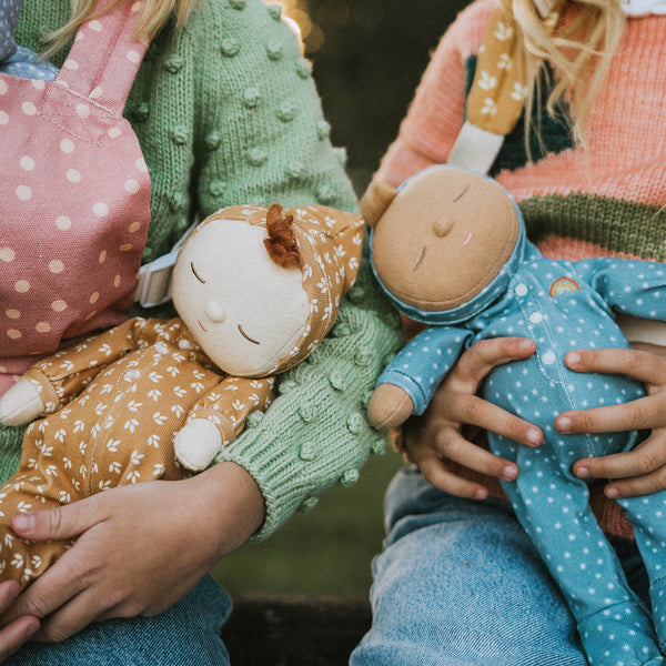 Gender-neutral posable plush doll with tan coloured velvety onsie outfit. Perfectly weighted for cuddles and bedtime. Suitable toy from birth.