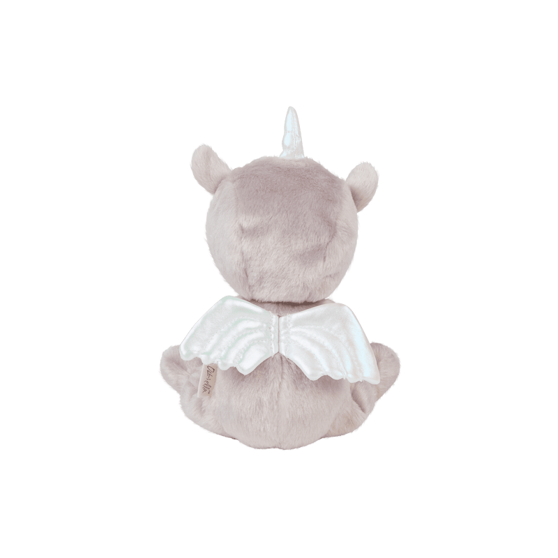 Back view of Dinky Dinkums Uma unicorn doll in soft lilac plush with a pale horn, rounded ears, and a white winged cape from the Unicorn Collection