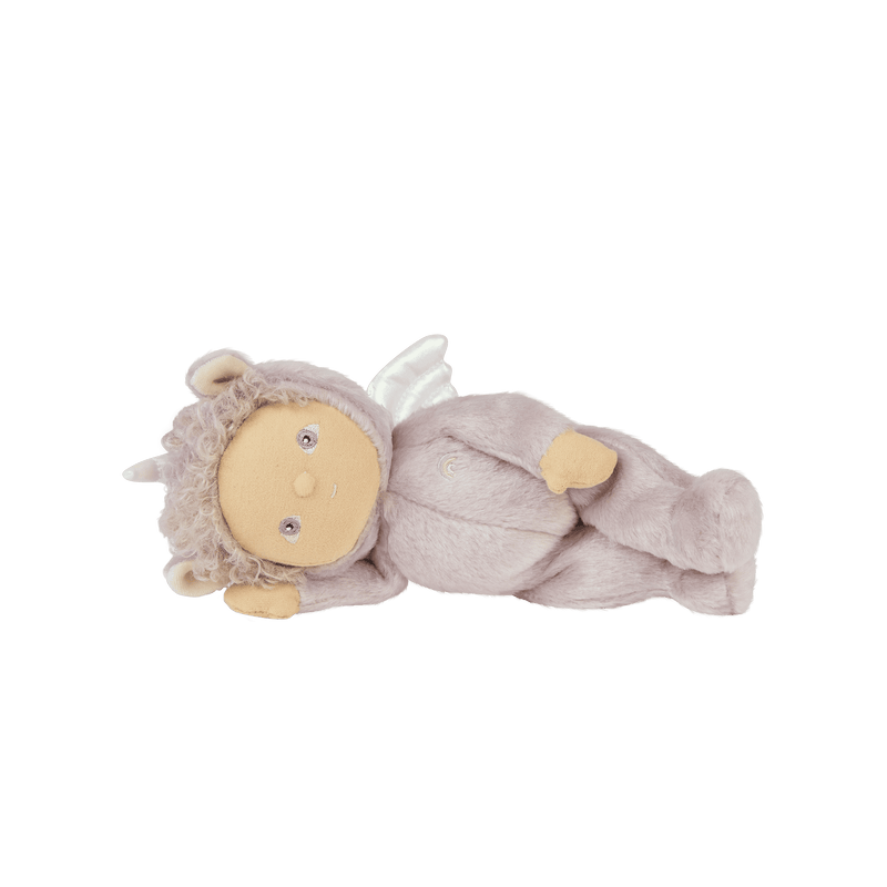 Dinky Dinkums Uma Unicorn doll in a soft lilac outfit with curly hair, a small horn, wings and rounded ears, lying on her back.