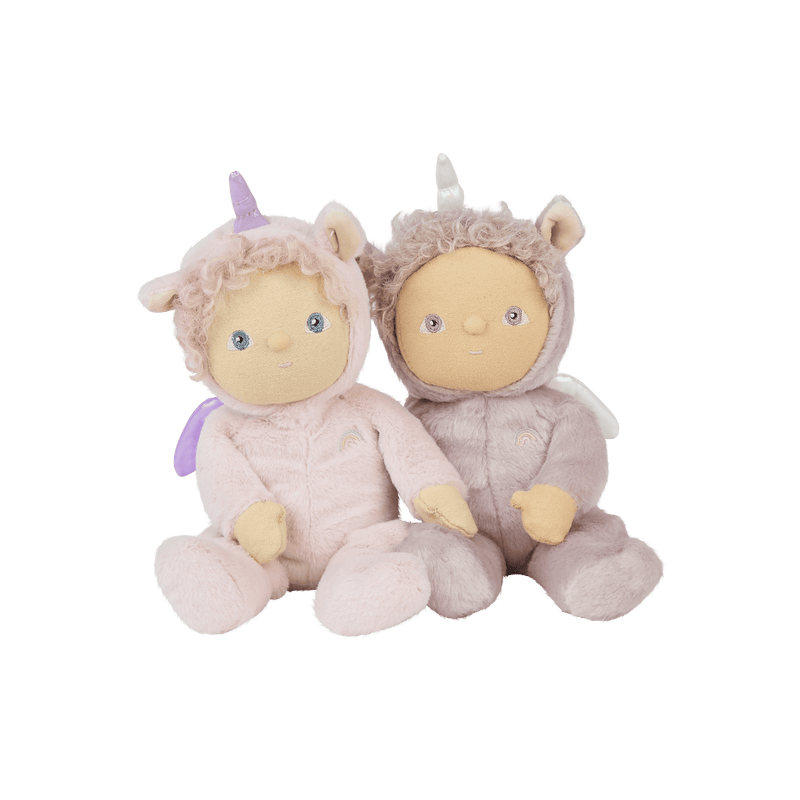 Two Dinky Dinkums unicorn dolls sitting together, one in a soft lilac outfit and one in a cozy taupe outfit, each with curly hair and a unicorn hood.