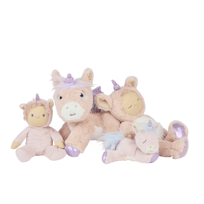 Four pastel Dinky Dinkums unicorn dolls in pink cream and lavender with soft plush bodies horns colorful manes and sweet embroidered faces arranged together