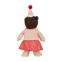 back of doll with hat, pink cardigan and spot dress