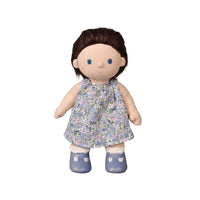 Doll with a floral dress and blue shoes on a white background