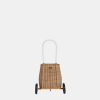 Natural rattan toddler basket with two black wheels and a white arched handle, shown from the front on a light background