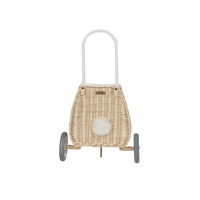 Rattan bunny luggy basket with a woven body, fluffy white tail, tall handle, and two wheels, designed for children by Olli Ella Kids Rattan