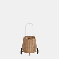 Natural rattan wheeled basket with a tall white pull handle, shown against a plain light background