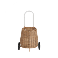 Natural rattan wheeled basket with a white loop handle, designed for toddlers to store and carry treasured belongings from room to room