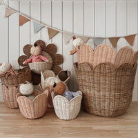 Functional pink rattan storage basket. Featuring scalloped edges, this basket is the perfect size for storing toys, laundry, towels and more. Use as décor storage in nurseries, bedrooms or anywhere in your home. 