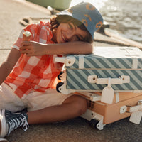 Stylish kids travel suitcase in blue striped design. Perfect for kids' travel, featuring a durable, lightweight build and eco-friendly materials. Made from recycled plastic bottles.