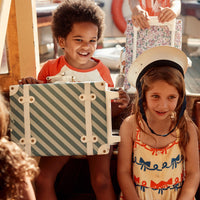 Charming blue striped kids travel suitcase by Olli Ella. Ideal for children's travel, with a spacious interior and playful colours. Constructed from recycled plastic bottles
